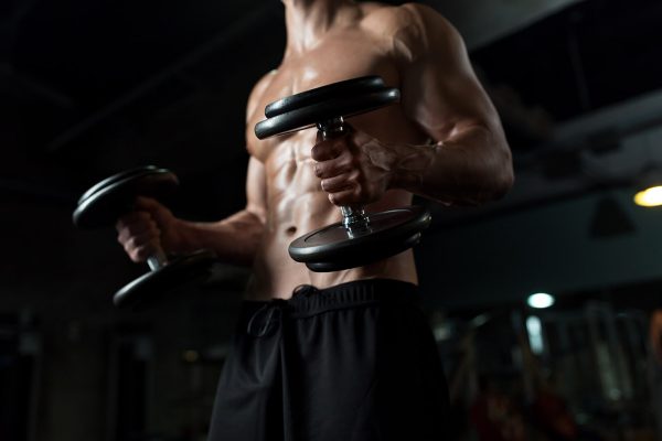close-up-of-man-with-dumbbells-exercising-in-gym-PNGBLV9-min.jpg
